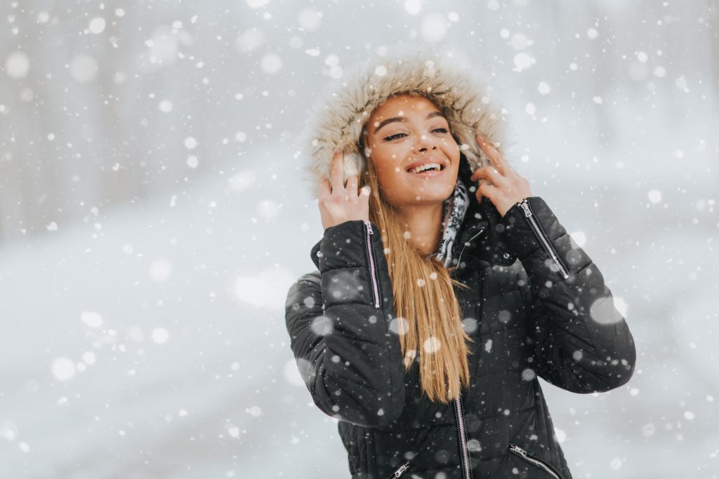 Lady covered in jacket in the snow